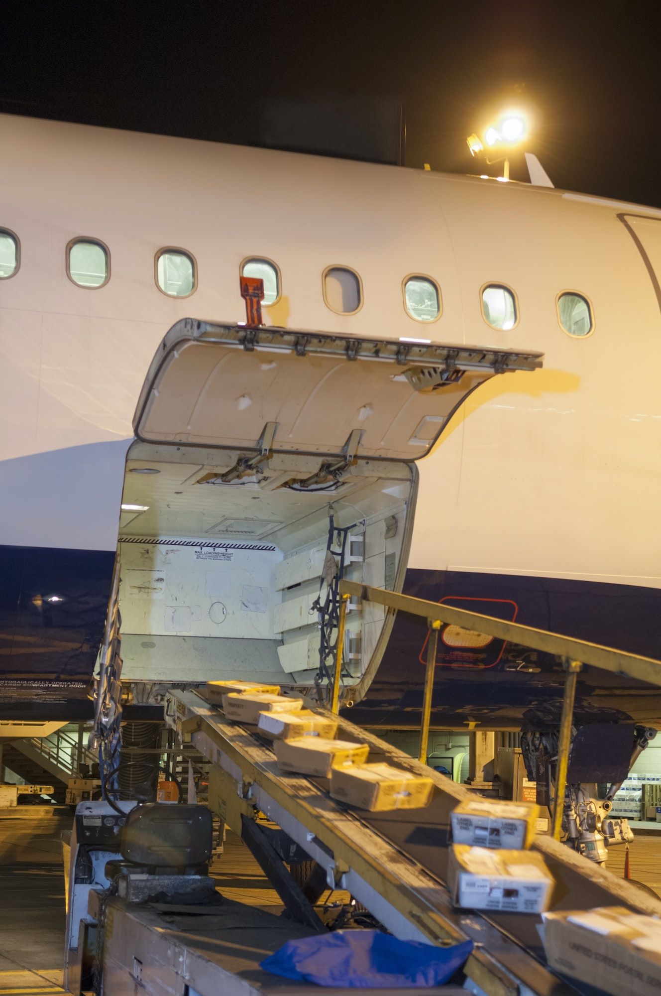 Packages Being Loaded In Cargo Airplane During Night